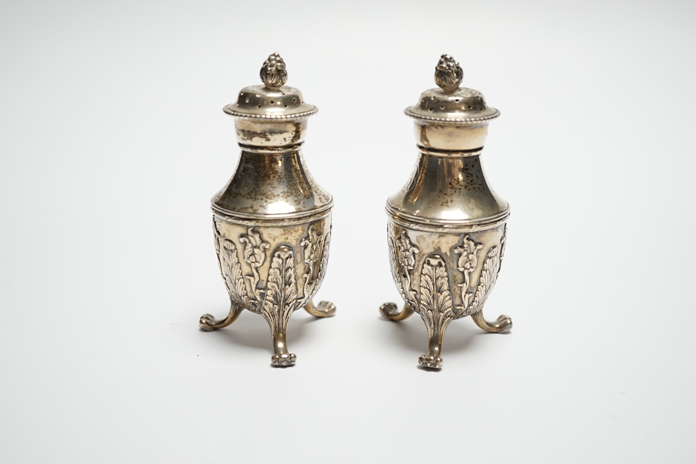 A pair of late 19th century Tiffany & Co sterling pepperettes, on tripod supports, 9cm, 157 grams.